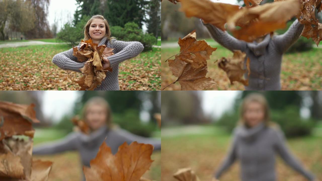 女孩微笑着向镜头扔秋叶