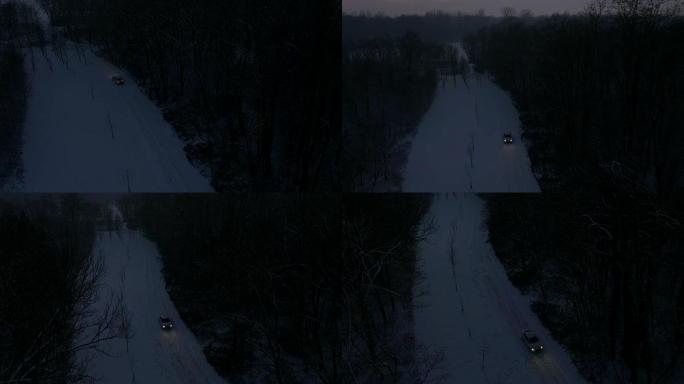 空中汽车在夜间沿着积雪覆盖的乡村道路行驶