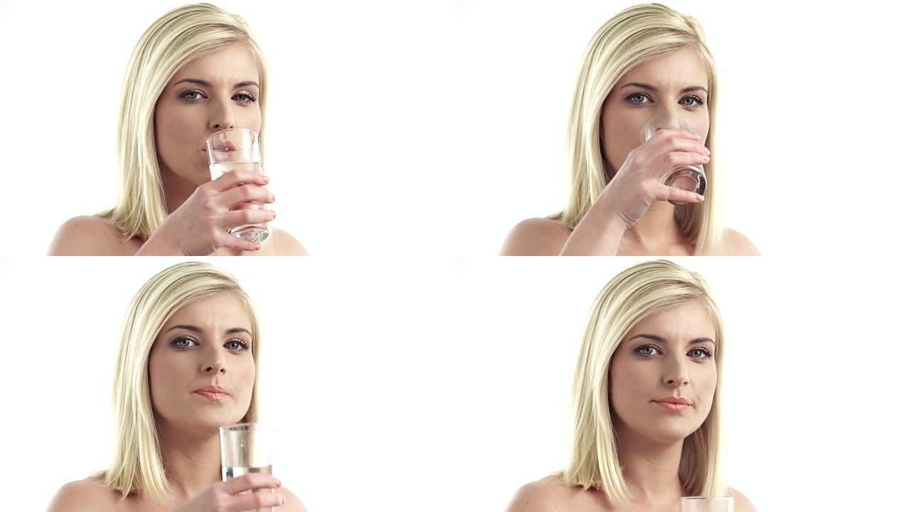 年轻女子喝水年轻女子喝水饮用水玻璃杯