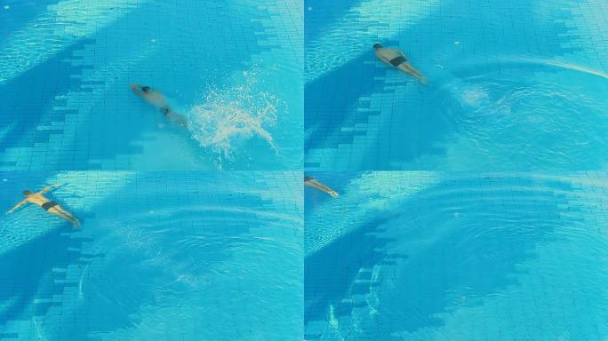 高清慢速动作：男子跳进游泳池