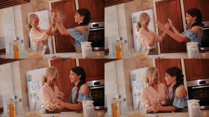 快乐的祖母在厨房里和孙女一起烘烤时高五