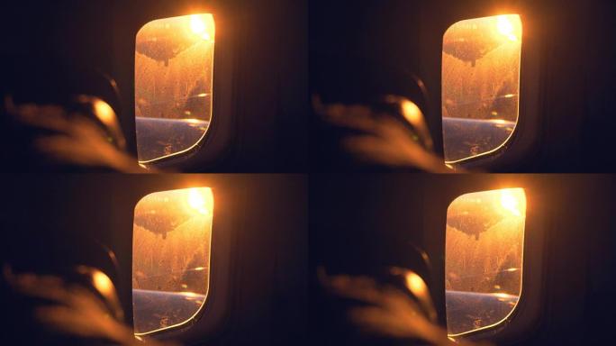 飞行过程中通过飞机窗口观看日出