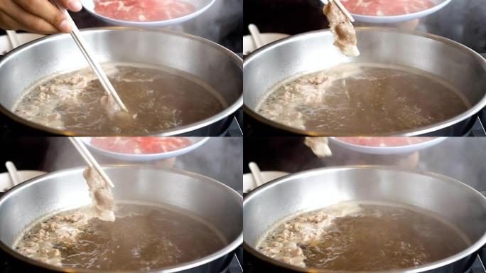 慢动作FHD剪辑在筷子，sha锅和Sukiyaki日式食品概念搅拌的煮汤火锅中蘸猪肉切片的镜头
