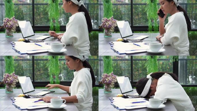 美丽的年轻应变亚洲妇女在笔记本电脑上工作，而不高兴在家里的客厅使用智能手机。亚洲商界女性家庭办公室工