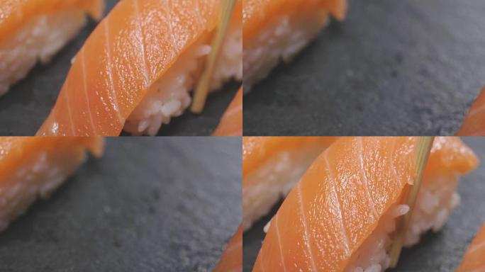 寿司质量高打开黑色背景，显示其所有的美味，饮食和健康的食物，咸味，寿司与鲑鱼或金枪鱼搭配很好，是典型