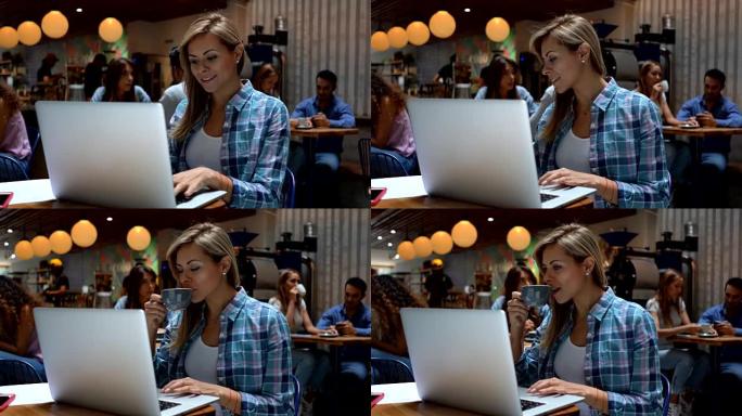 自信的女人在咖啡店里用笔记本电脑工作，同时享受美味的咖啡