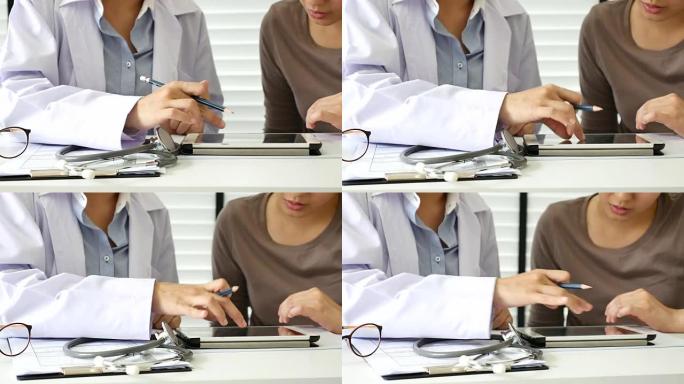 医生和病人在办公室用数字平板电脑交谈
