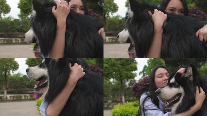 快乐的年轻亚洲女人抱着她的狗阿拉斯加雪橇犬户外，4k