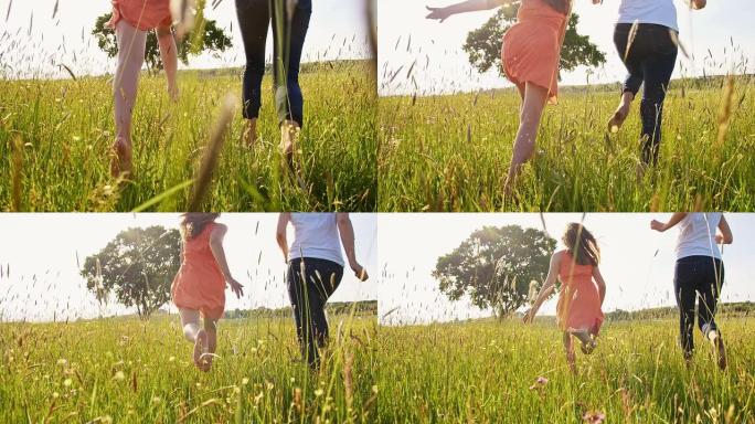 SLO MO开朗的女人和女孩在草地上赤脚奔跑