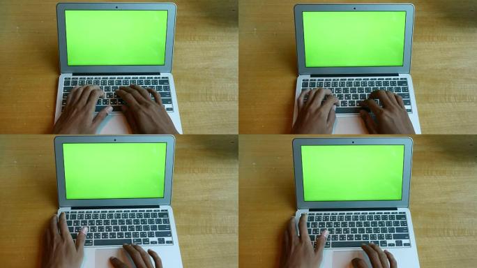 手动打字笔记本电脑，木桌背景上有绿屏，4k(UHD)