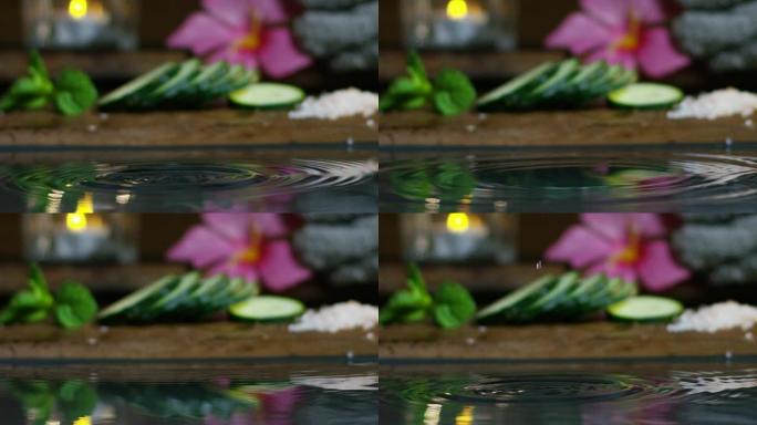 美丽的水和蜡烛水疗和健康组合以极端慢动作拍摄。放松和冥想的概念。水