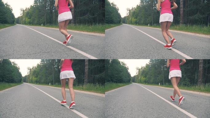 年轻健康的女人在路上奔跑。健康的生活方式理念。
