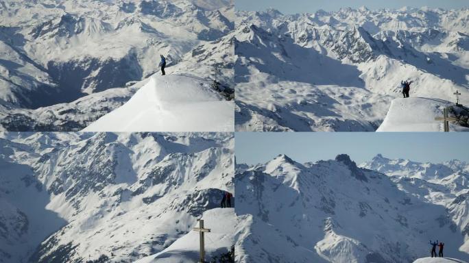 登山者在白雪覆盖的山峰上欢呼雀跃