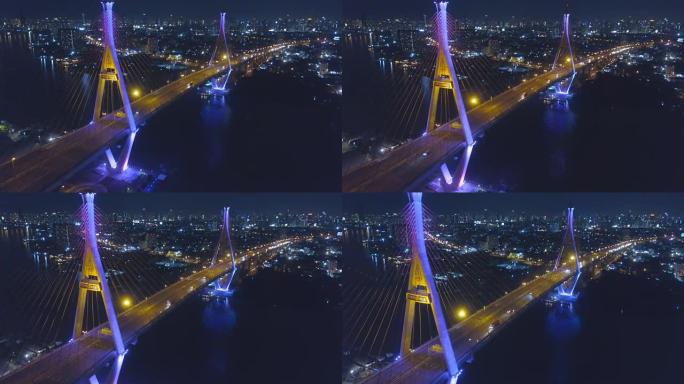 普密蓬大桥工业环桥两次穿越湄南河的鸟瞰图。泰国曼谷新地标的暮色，灯光秀和日落场景