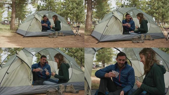 夫妇在帐篷里打牌热恋情侣山林中休闲娱乐周