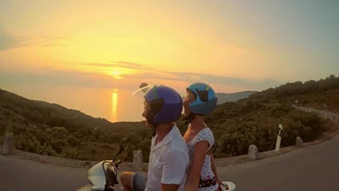 POV欣喜若狂的夫妇在日落时骑着踏板车