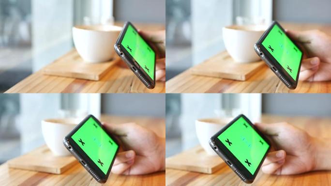 4K: 在咖啡店使用智能手机的特写镜头，绿屏