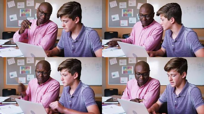 高中导师给男学生在办公桌上使用笔记本电脑一对一的学费