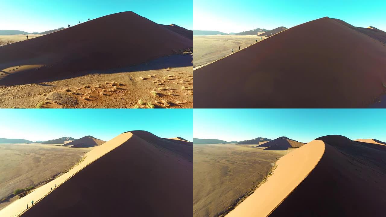 直升机游客在纳米比亚沙丘上徒步旅行