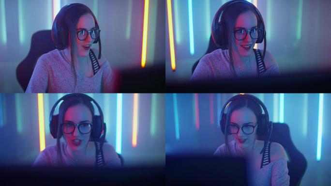 美丽的职业玩家女孩坐下来在她的个人电脑上玩在线视频游戏。戴着眼镜对着麦克风说话的休闲可爱怪胎。网络体
