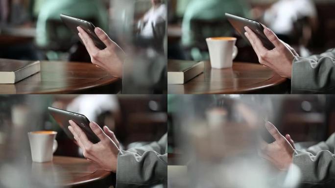咖啡馆里有数字平板电脑的女人