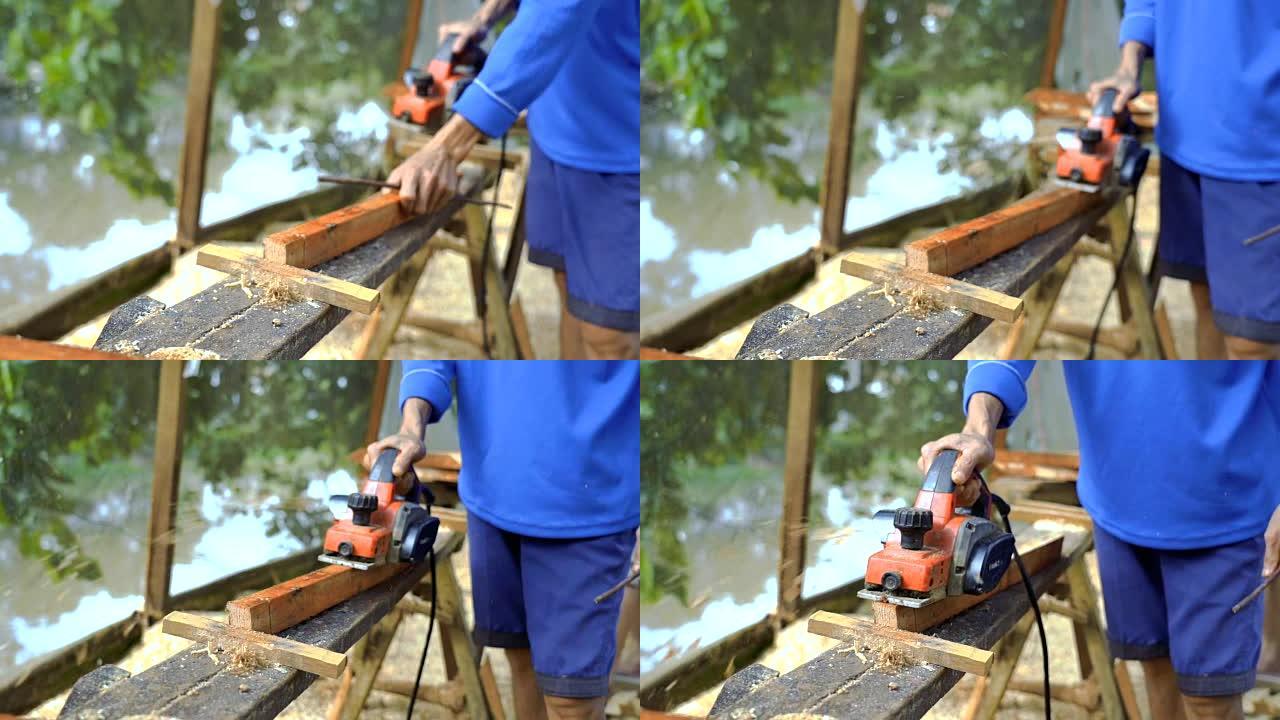 亚洲工人在越南东塔丁安计划机器刨削木材的慢动作FHD镜头，木工工具和机器概念