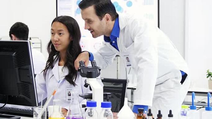 男科学家和女科学家都在实验室工作。在生命科学实验室工作的卫生保健研究人员。
