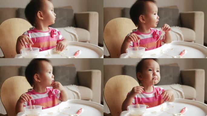 可爱小宝宝自己学习吃饭用手抓面条