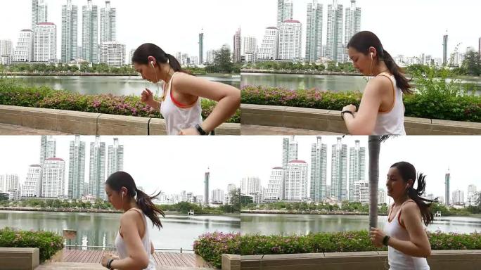 年轻女子在城市用智能手表和耳塞慢跑