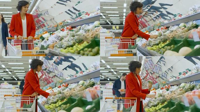 在超市: 美丽的年轻女子走过新鲜农产品区，选择西兰花并将其放入购物车。