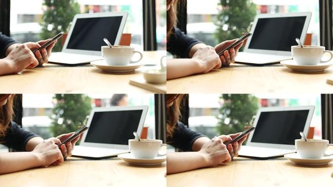 关闭女人的手发短信，在咖啡馆使用智能手机