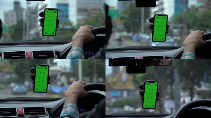驾驶员在汽车中使用带有绿屏的智能手机