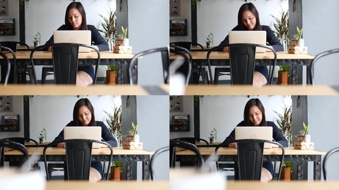 多莉在咖啡馆用笔记本电脑射击女商人