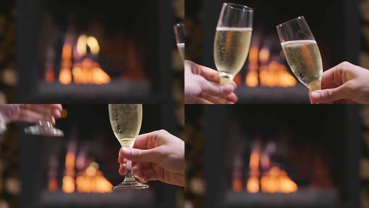 一个冬天的晚上，一对夫妇坐在壁炉前放松，一边喝一杯酒，一边敬酒，一边享受壁炉的温暖。概念: 假期、放
