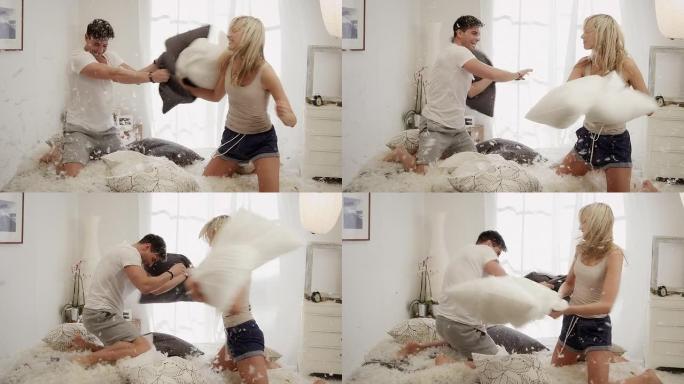 情侣在卧室里用枕头打架
