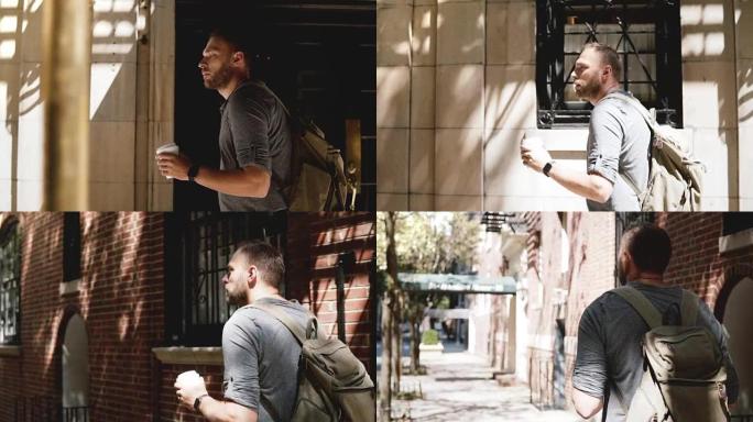 年轻轻松的自由职业者背着背包走在阴凉的夏季城市街道建筑上，咖啡四处张望