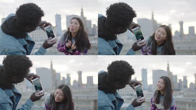 亚洲妇女用智能手机在屋顶上向摄影师摆姿势