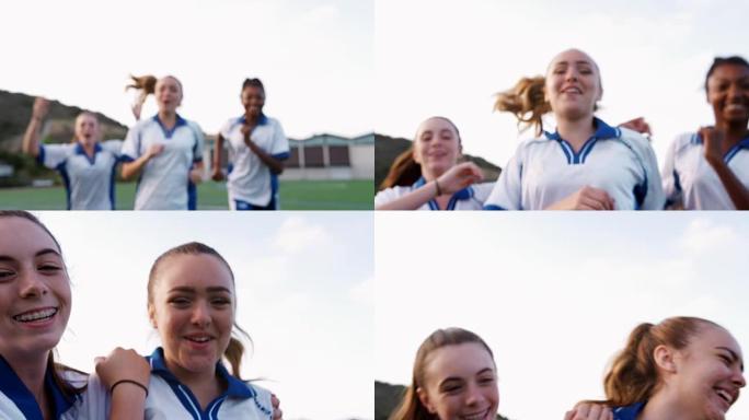 女子高中足球队奔向镜头并庆祝的肖像