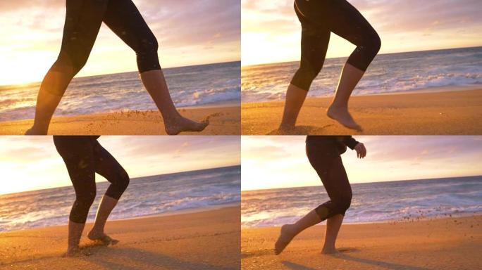低角度: 年轻女子在沙滩上慢跑时在空中踢棕色的沙子