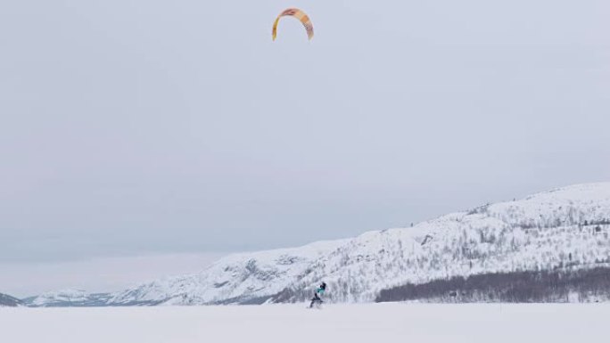 SLO MO风筝冲浪者在雪中滑雪