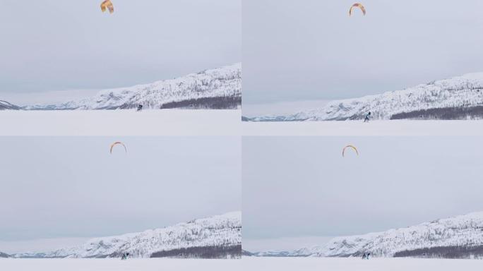 SLO MO风筝冲浪者在雪中滑雪