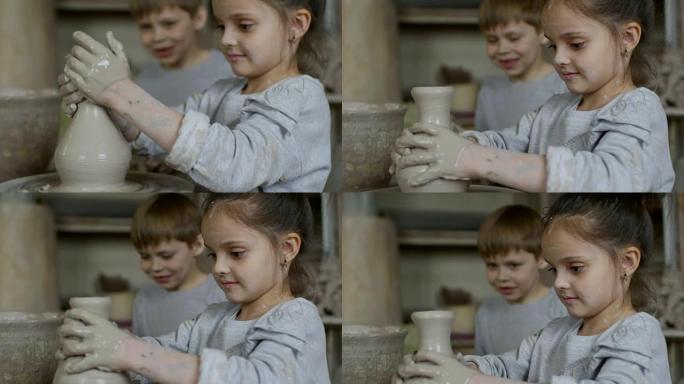 在陶艺课上制作粘土花瓶的小女孩
