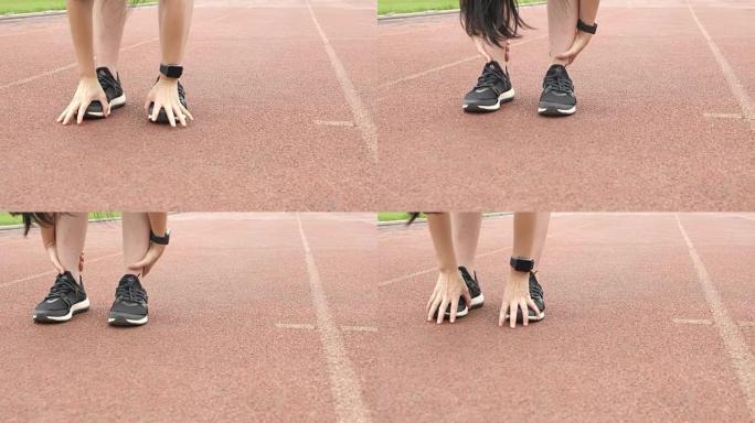 女人跑步前热身操场上的脚运动鞋