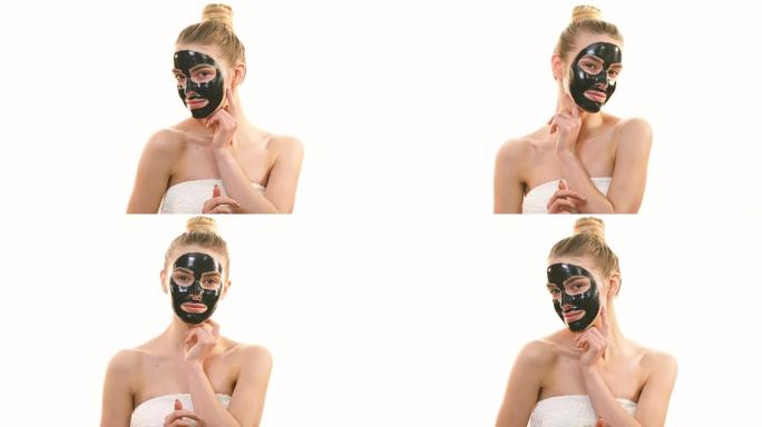 黑脸护理面具的幸福女人在白底调情