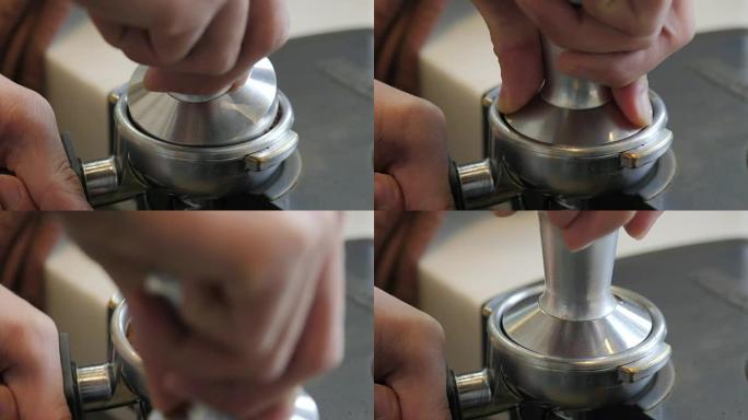 咖啡研磨机的咖啡粉。浓缩咖啡捣固。特写咖啡师通过篡改咖啡将研磨咖啡压入portafilter