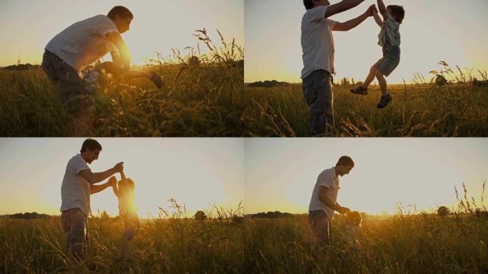SLO MO父亲与儿子在草地上玩耍