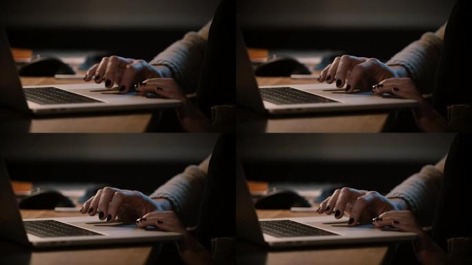 使用笔记本电脑触控板的特写女性手指。女人上网，深夜手放在笔记本触摸板上。4K