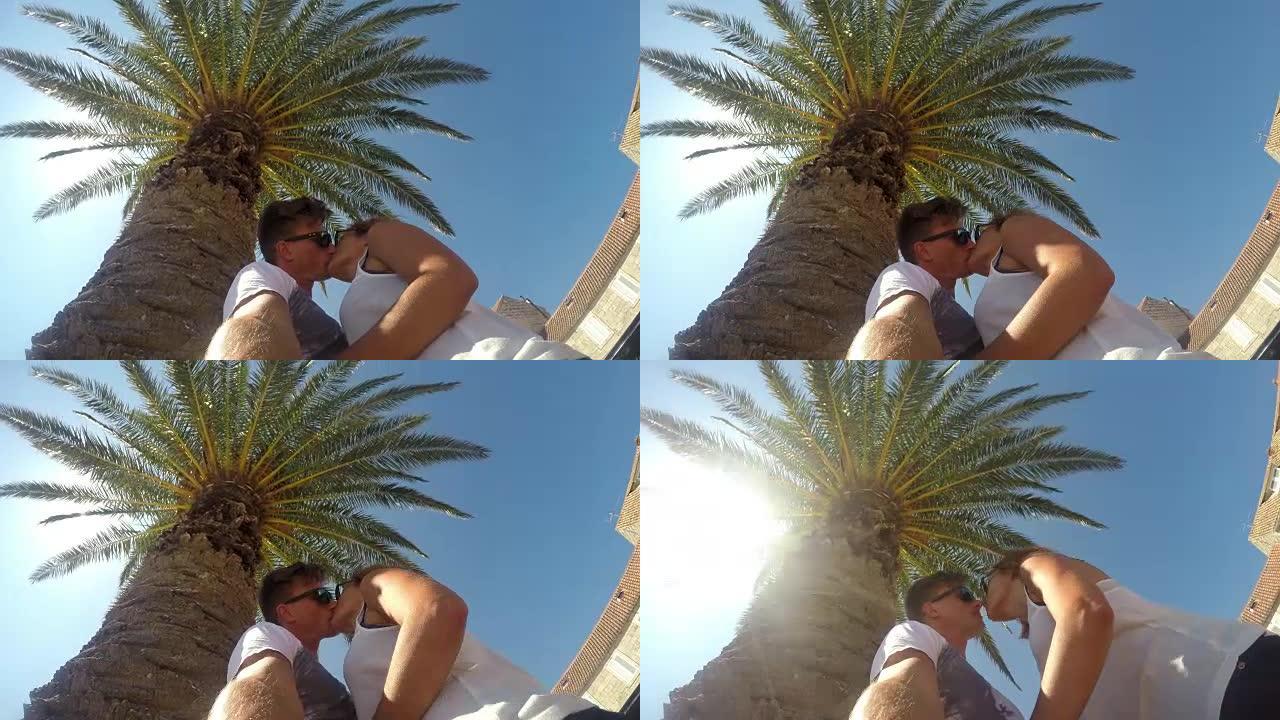 WS夫妇在棕榈树下接吻