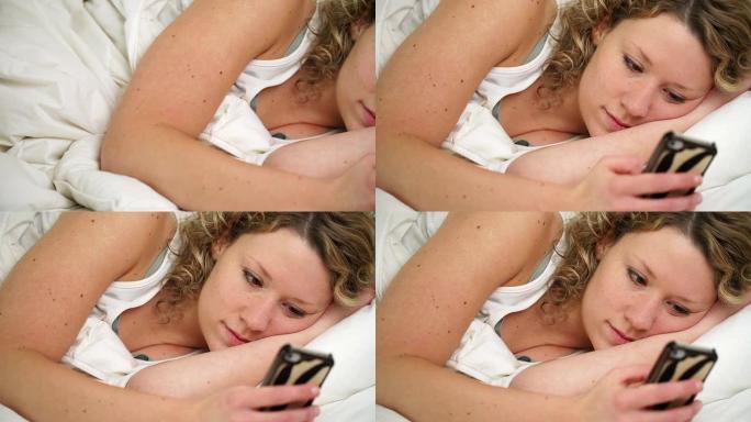 短信外国女人躺着玩手机