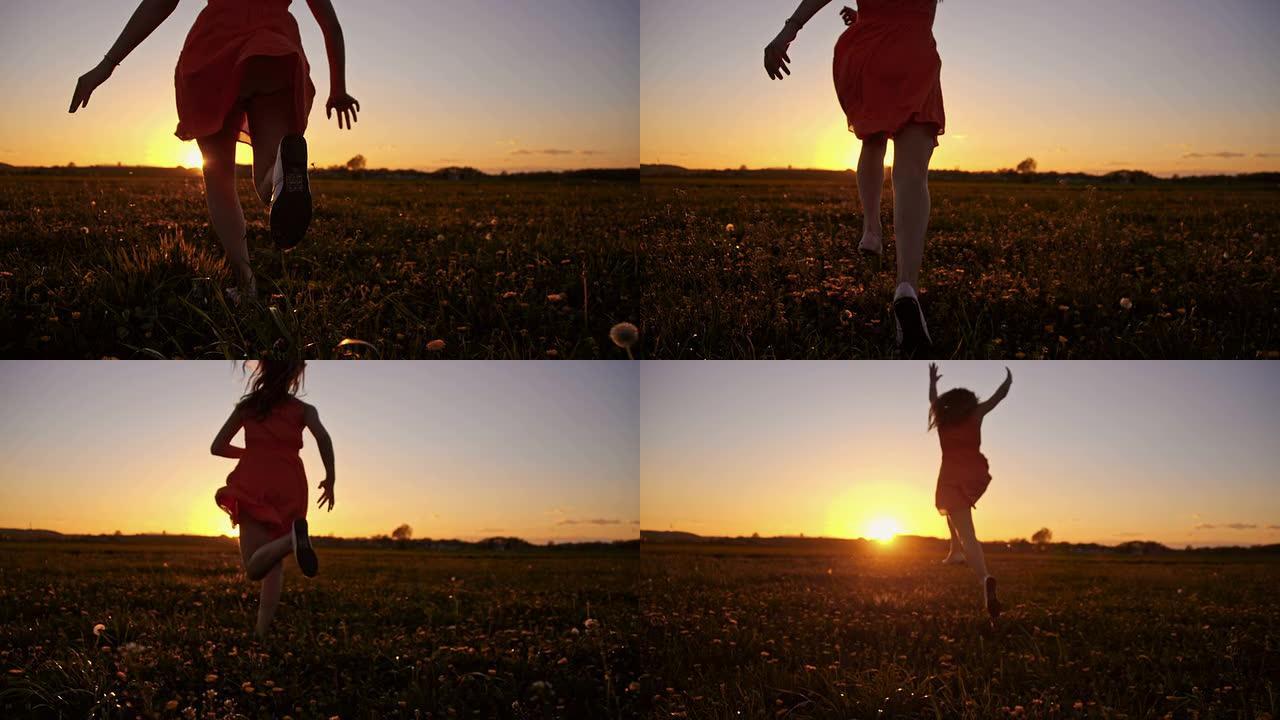 日落时在草地上奔跑的SLO MO快乐女孩